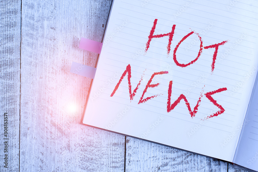 Writing note showing Hot News. Business concept for subject that experiences surge in popularity on social media Notebook stationary placed above classic wooden backdrop