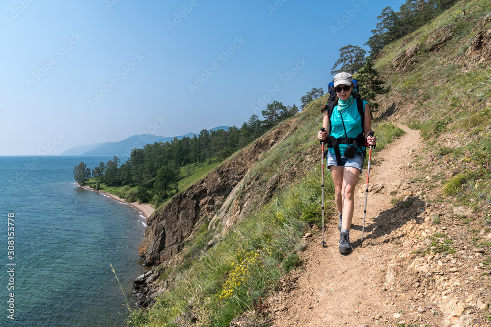 Girl tourist walks along the Great Baikal trail