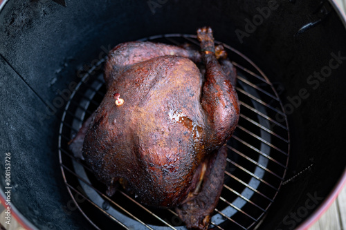 Cooked smoked turkey on smoker grill 