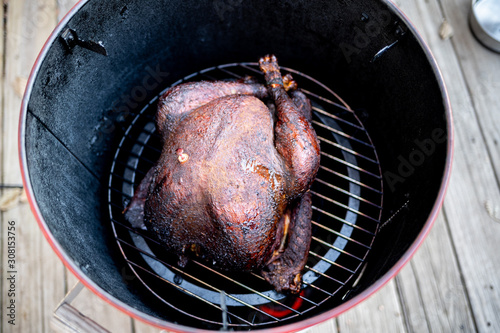 Smoked turkey resting on smoker grill