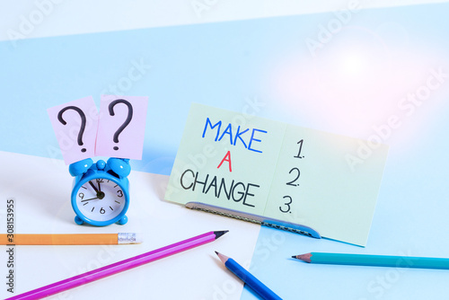 Text sign showing Make A Change. Business photo text Create a Difference Alteration Have an Effect Metamorphose Mini size alarm clock beside stationary placed tilted on pastel backdrop photo