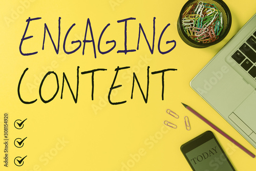 Text sign showing Engaging Content. Business photo showcasing provides value to the lives of your potential clients Slim trendy laptop pencil smartphone clips container colored background