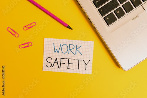 Word writing text Work Safety. Business photo showcasing policies and procedures in place to ensure safety in workplace Trendy metallic laptop clips pencil squared paper sheet colored background photo