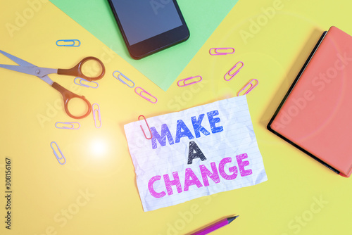 Text sign showing Make A Change. Business photo text Create a Difference Alteration Have an Effect Metamorphose Paper sheets pencil clips smartphone scissors notebook colored background photo