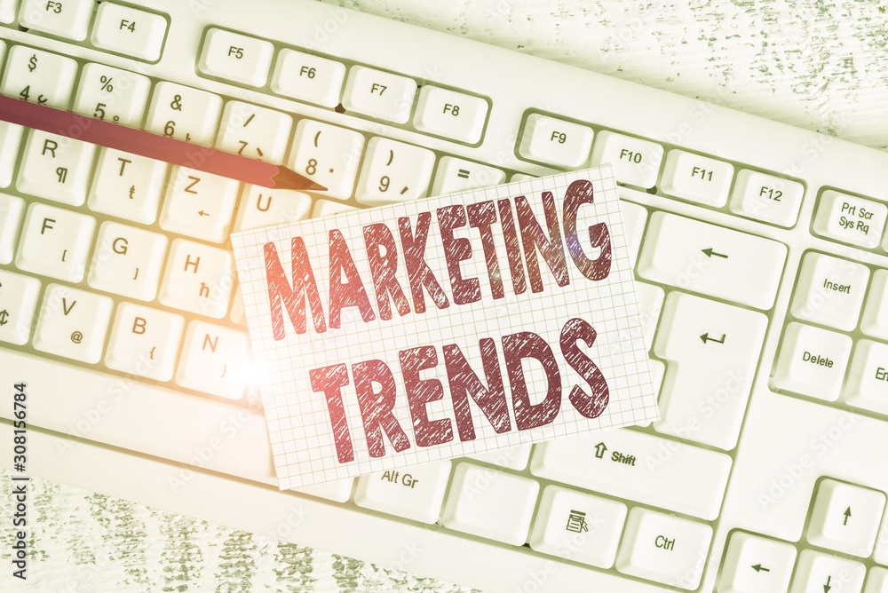Word writing text Marketing Trends. Business photo showcasing changes and developments in trading in the market White keyboard office supplies empty rectangle shaped paper reminder wood