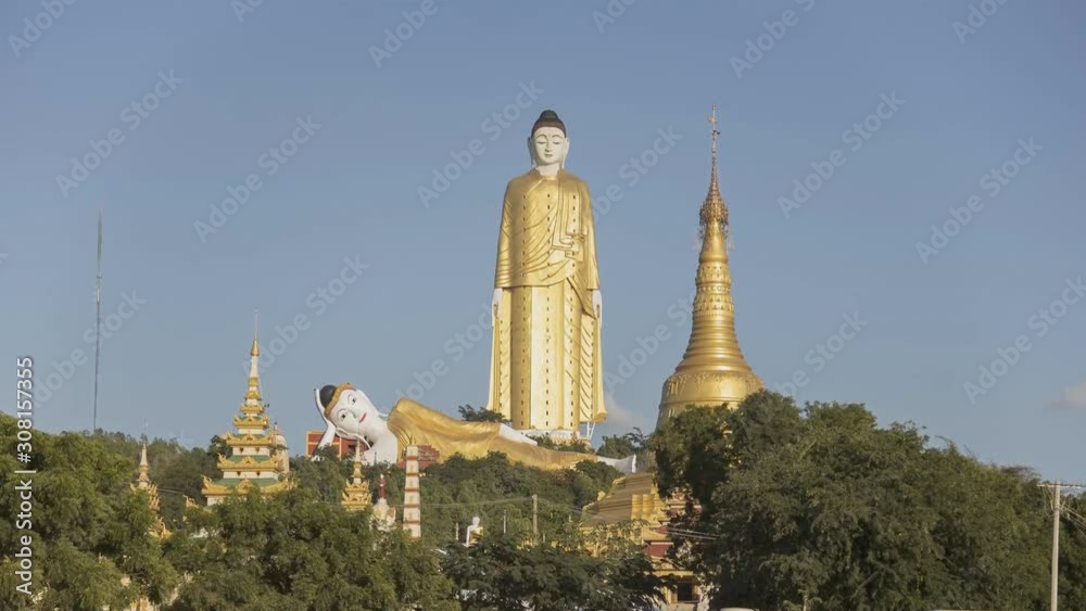 MONYWA, MYANMAR - Gate of Aung Sakkya Pagoda of Maha Bodhi Ta Htaung monastery with , Aung Sakkya Pagoda and Buddha statues (time-lapse)