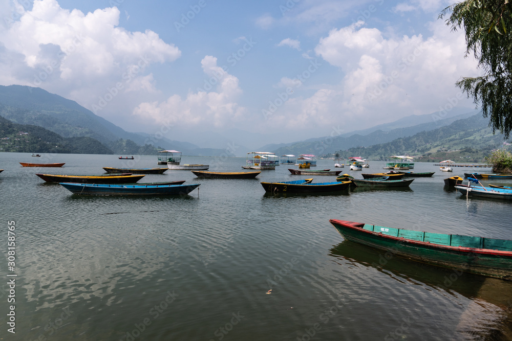 Phewa Lake a Cloudy Day and wooden color Boats Phewa Lake a Cloudy Day and wooden color Boats
