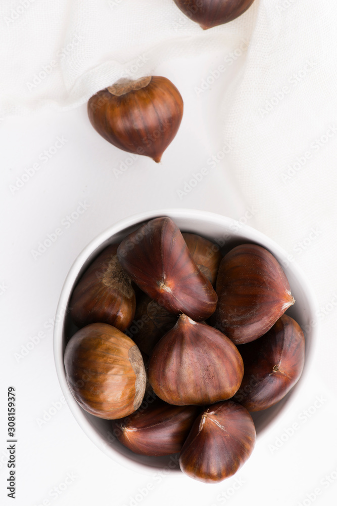 Bowl of chestnuts on a white background Bowl of chestnuts on a white background