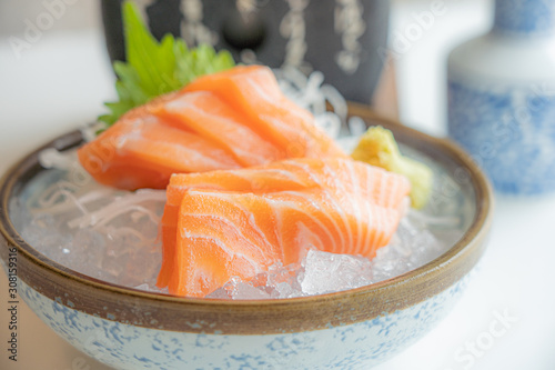Fress fresh traditional Japanese healthy food name’s sashimi salmon served on ice in a bowl in a Japaneses restaurant..