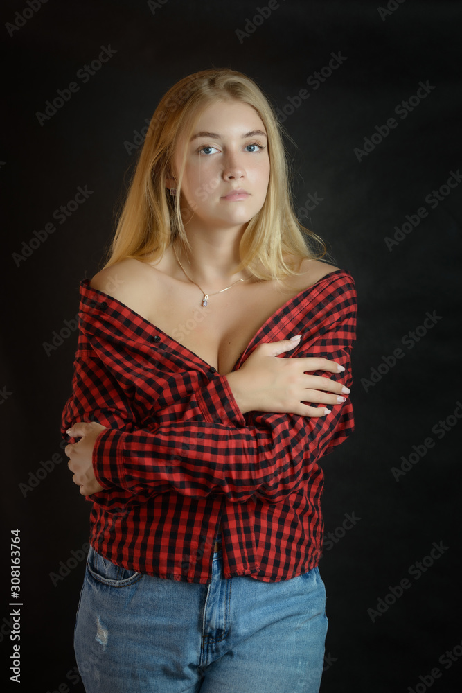 Portrait of beautiful woman with blue eyes in black-red shirt. Portrait of beautiful woman with blue eyes in black-red shirt.