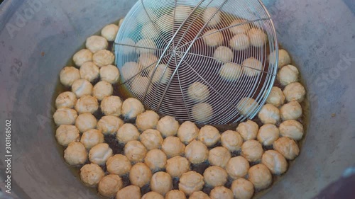  Fry meatballs in a frying pan street food in thailand.
