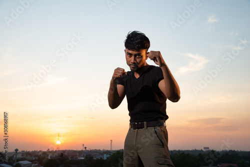 man posing mauy thai in rooftop