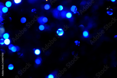  Garland lights on the Christmas tree. Blurred defocused christmas background for design.