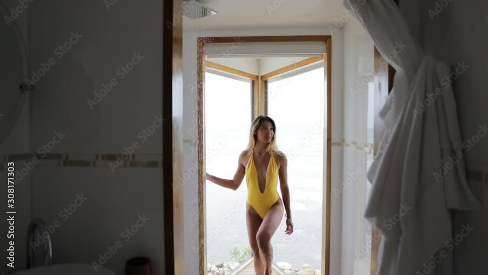 Beautiful Girl Model in Yellow Bikini in Luxury White Beach House Shower Beautiful Girl Model in Yellow Bikini in Luxury White Beach House Shower