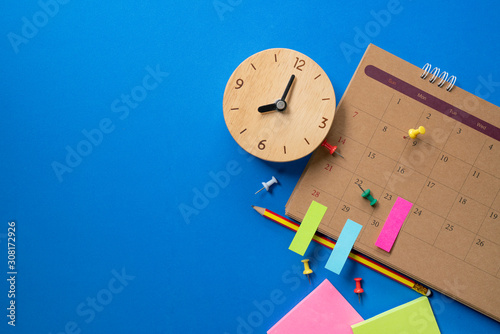 Tableau sur toile close up of calendar and alarm clock on the blue table background, planning for