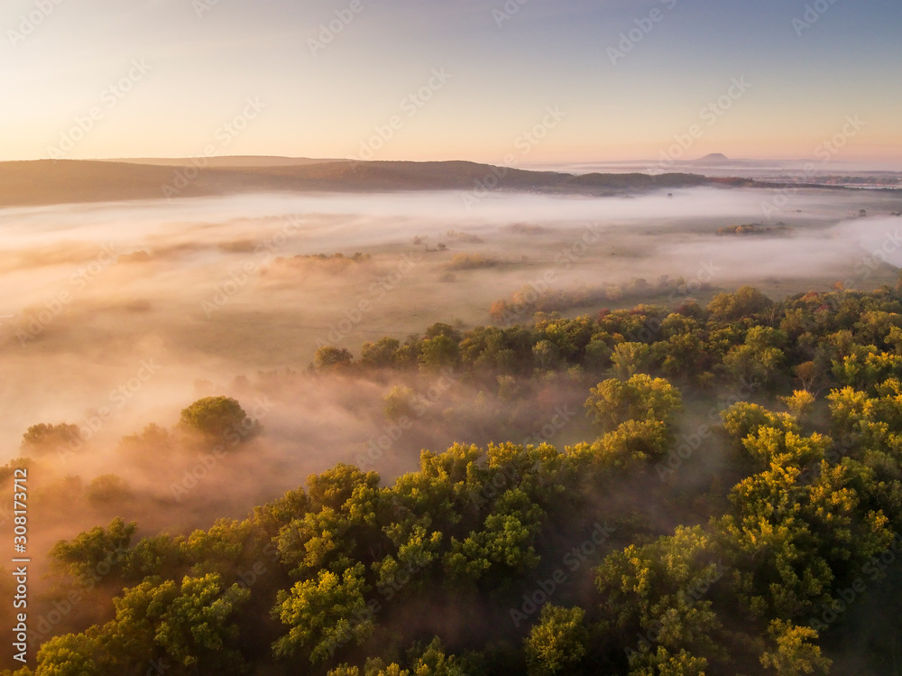 Floodplain of the Belaya river in foggy autumn morning. Aerial view.