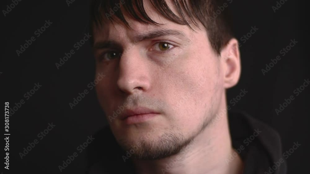 Close up emotional portrait of the young male being angry, frowning and grumpy. Halfturn head position Close up emotional portrait of the young male being angry, frowning and grumpy. Halfturn head position