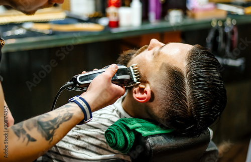 A man in a barbershop caring for his beard