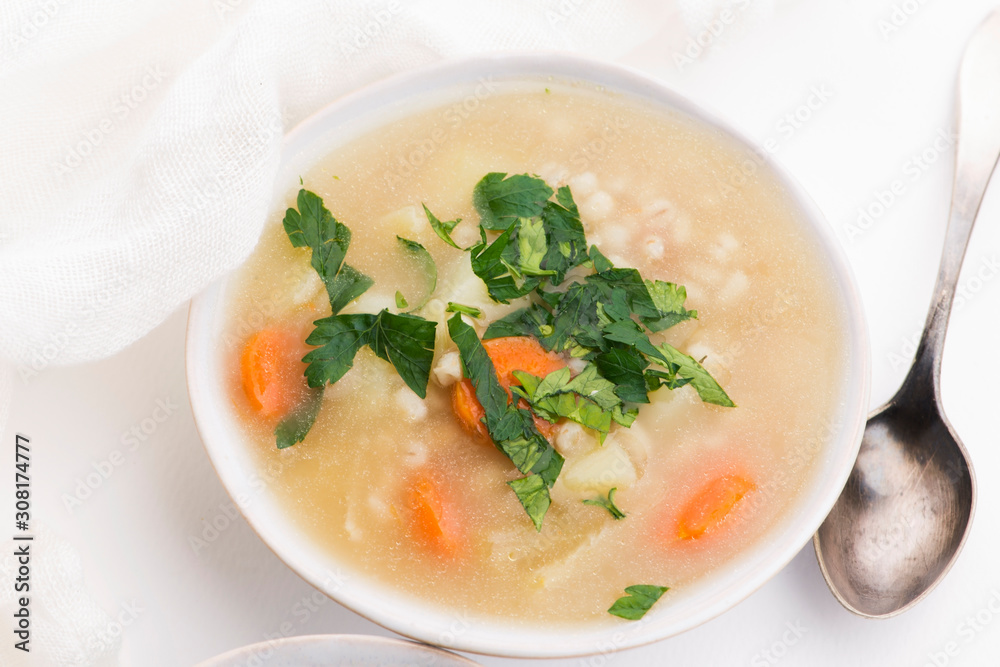 Barley soup, pearl barley in white bowl Barley soup, pearl barley in white bowl