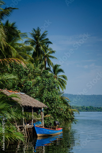boat and jungle hut on the tatai river in cambodia