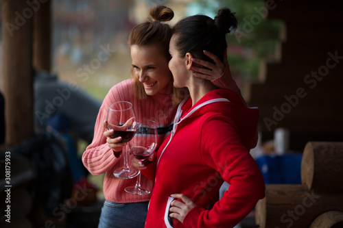 girlfriends drink wine on a picnic