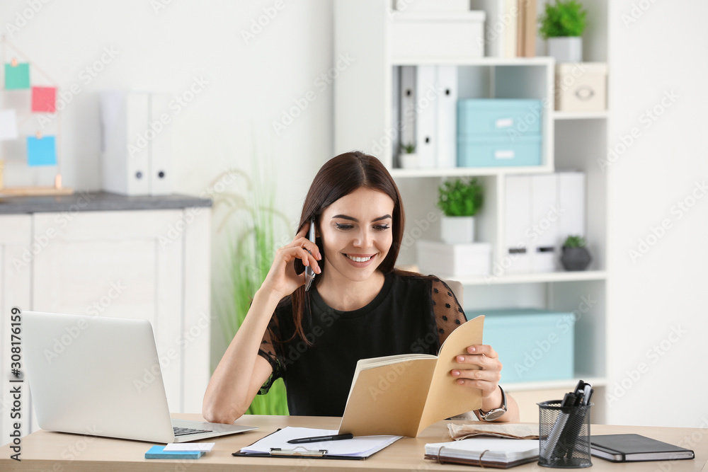 Beautiful young businesswoman working in office Beautiful young businesswoman working in office