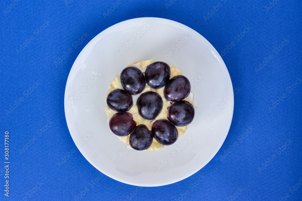 The legendary Tiffany layered salad with grapes, chicken and cheese on the blue background. The legendary Tiffany layered salad with grapes, chicken and cheese on the blue background.
