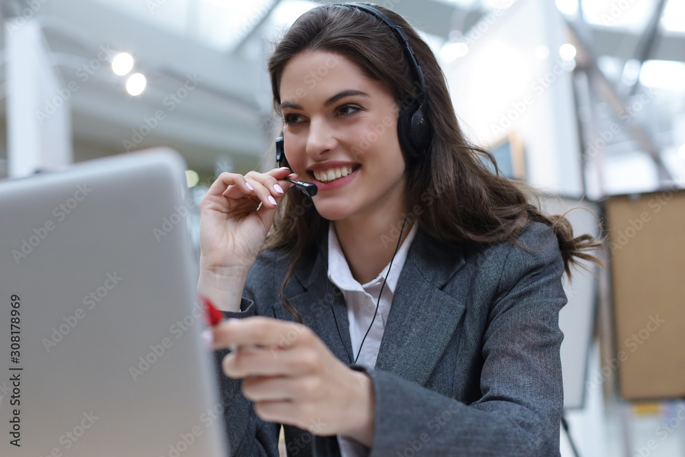 Woman customer support operator with headset and smiling. Woman customer support operator with headset and smiling.