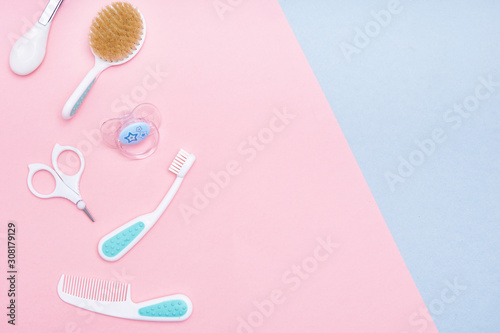 Baby accessories on pink and blue background. Flat lay . Top view Copy space.