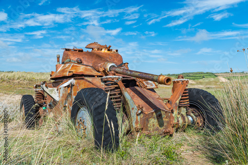 Foto Memorials of WWII: A rusty tank in the bombed dunes near Biville, Normandy, France