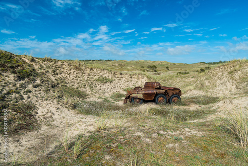 Memorials of WWII: A rusty tank in the bombed dunes near Biville, Normandy, France.