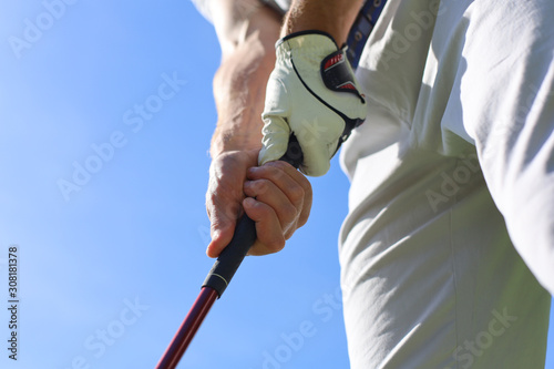 Canvas Print Golfer wearing a golf holding a putter.