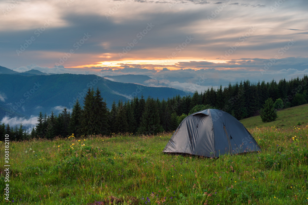 Camping tent in mountains at the evening