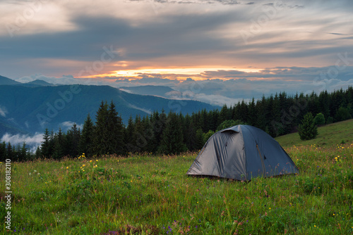 Camping tent in mountains at the evening