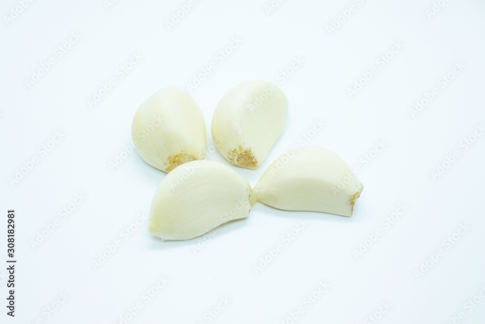 Garlic cloves located on a white background Garlic cloves located on a white background
