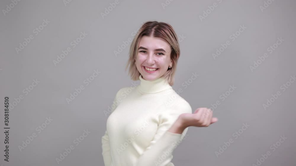 Young caucasian lady wearing white shirt looking so funny, over gray wall happy and pointing to herself, smiling