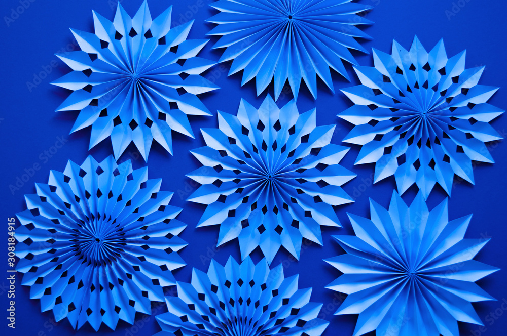 Trendy blue monochrome Christmas background. Diy paper snowflakes. Minimal monochrome christmas concept. Copy space. Flat lay style. Open composition. Color of the year 2020. Trendy blue monochrome Christmas background. Diy paper snowflakes. Minimal monochrome christmas concept. Copy space. Flat lay style. Open composition. Color of the year 2020.