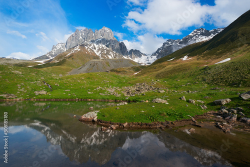 Mountain lake with reflection of high rocky peak © Sergey Ryzhkov