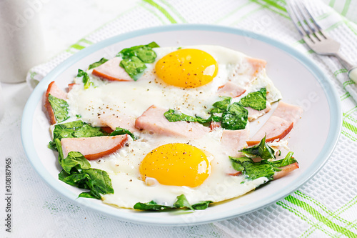 Fried eggs  with ham and spinach. Delicious English Breakfast. Brunch. Keto/paleo diet.