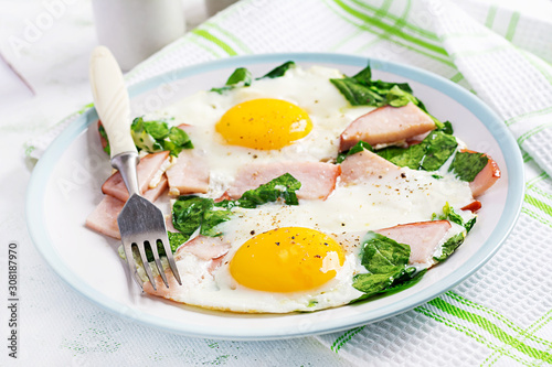Fried eggs  with ham and spinach. Delicious English Breakfast. Brunch. Keto paleo diet.