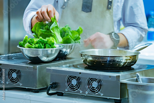 Cook is preparing a vegetab...