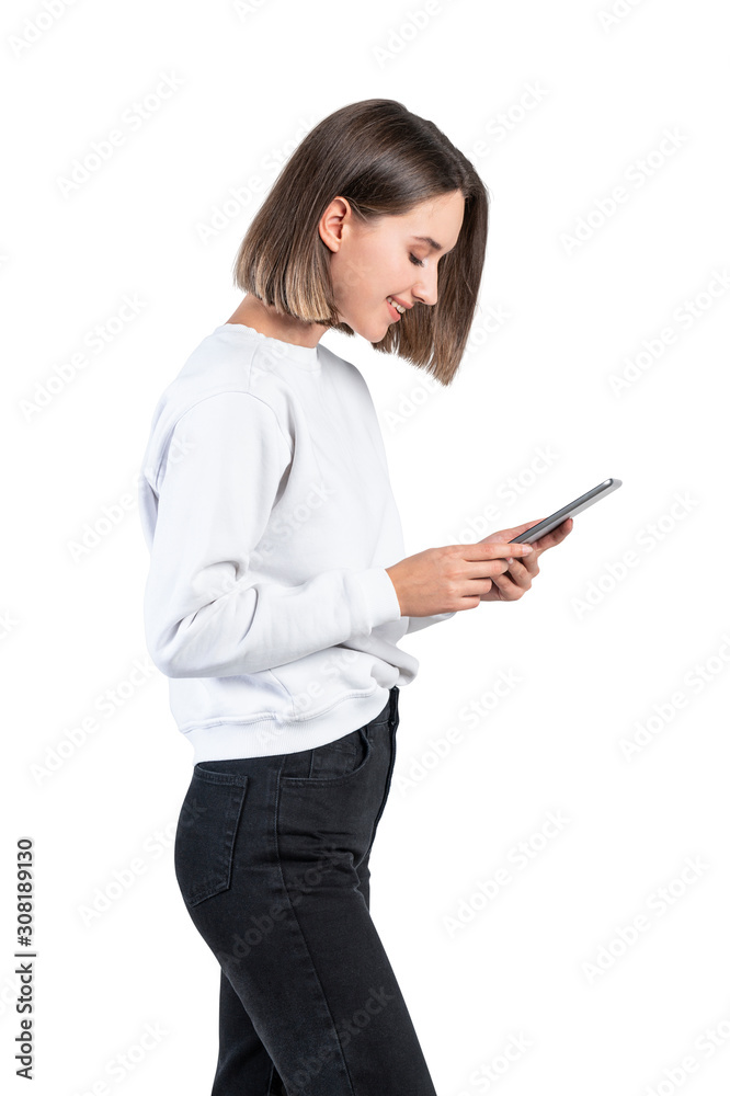 Smiling casual woman looking at tablet, side view Smiling casual woman looking at tablet, side view