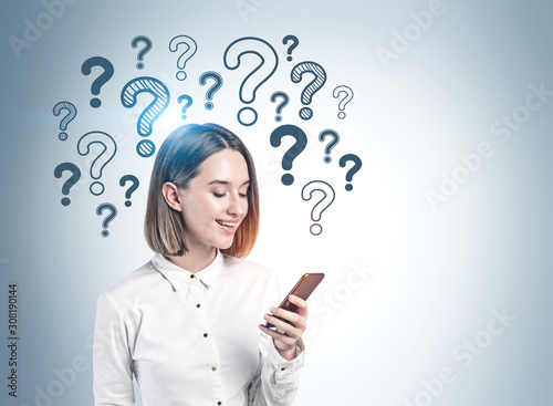 Woman with smartphone and question marks