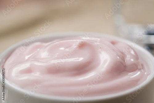 strawberry yogurt in white bowl closeup shot