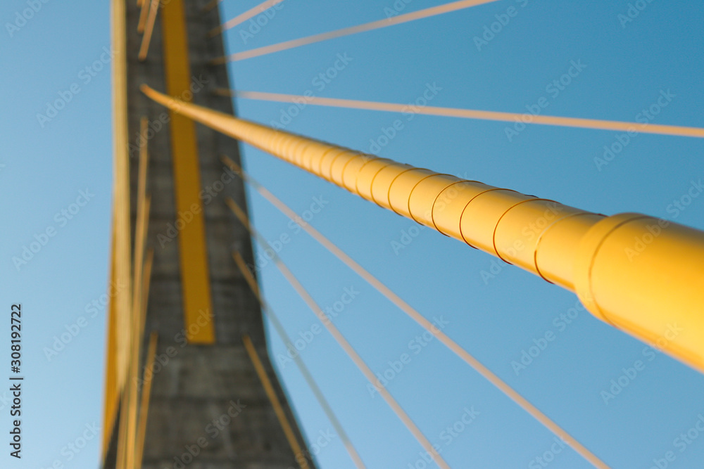 The yellow cable of the suspension bridge. The cable of the suspension bridge will have tension to support the weight of the bridge. The yellow cable of the suspension bridge. The cable of the suspension bridge will have tension to support the weight of the bridge.