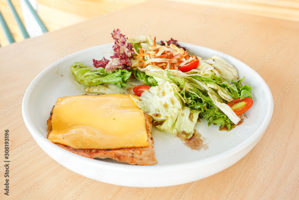 Grilled chicken steak with melted cheese and mixed salad Grilled chicken steak with melted cheese and mixed salad