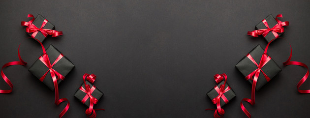 New years background. Christmas gifts, red decor on black backgr