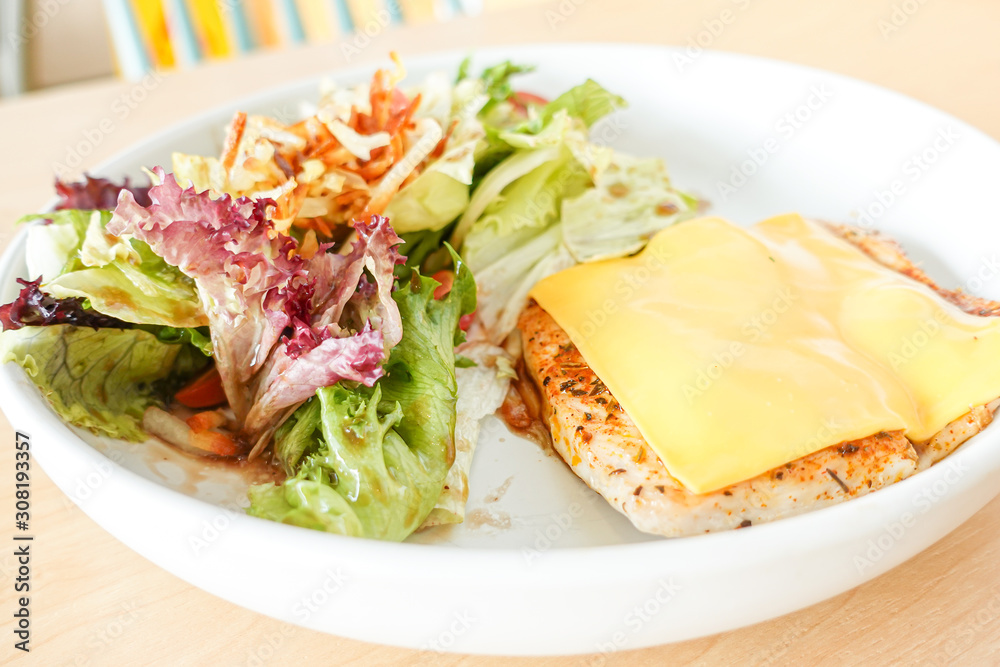 Grilled chicken steak with melted cheese and mixed salad Grilled chicken steak with melted cheese and mixed salad