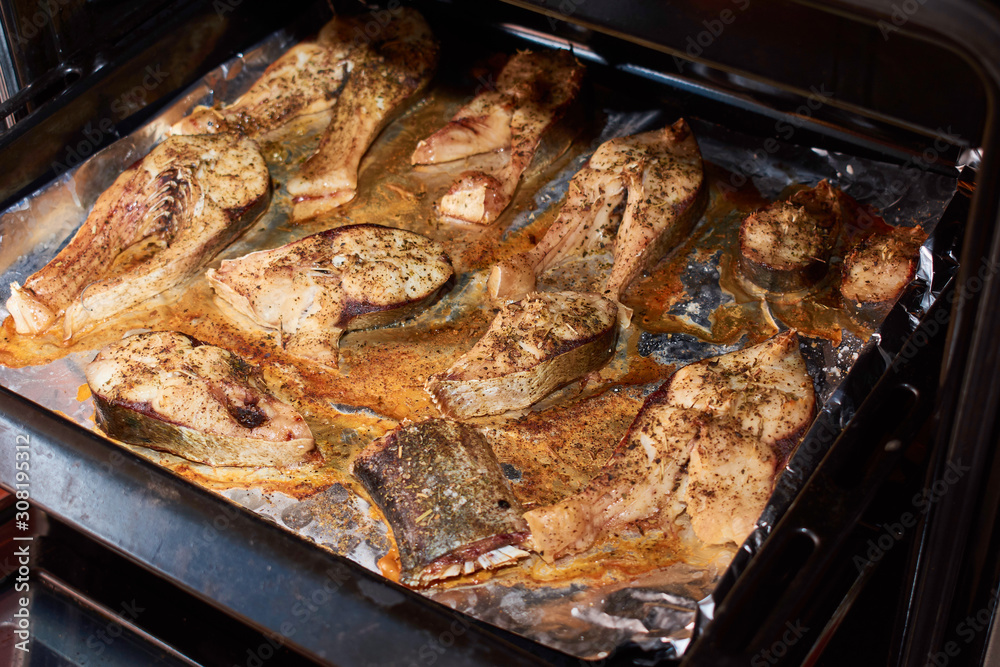 Cooking fish steaks in home kitchen. Preparing healthy and diet food Cooking fish steaks in home kitchen. Preparing healthy and diet food
