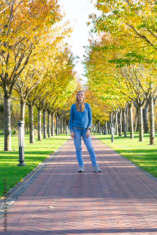 Portrait of young beautiful happy woman, autumn outdoors